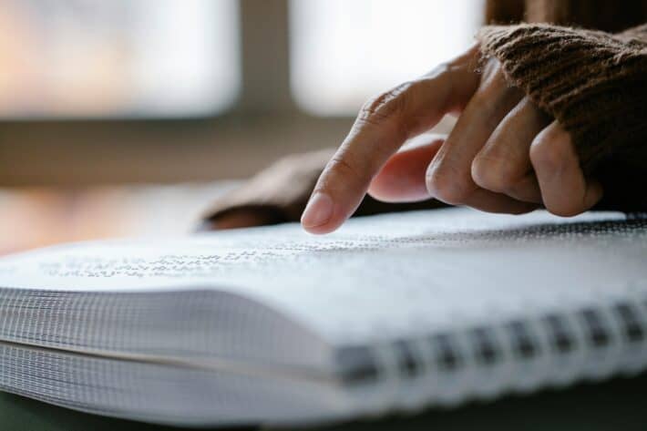 A person reading braille, highlighting accessibility